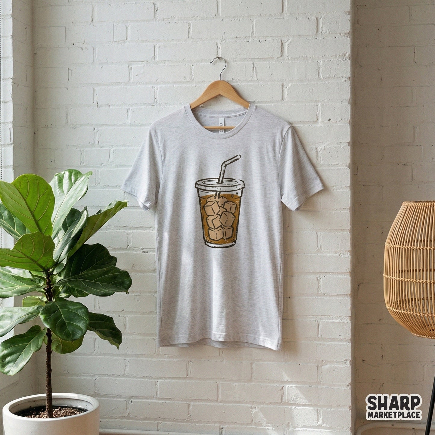 A trendy iced coffee cup graphic featuring a retro, grainy texture displayed on a heather gray t-shirt for apparel or sublimation projects.