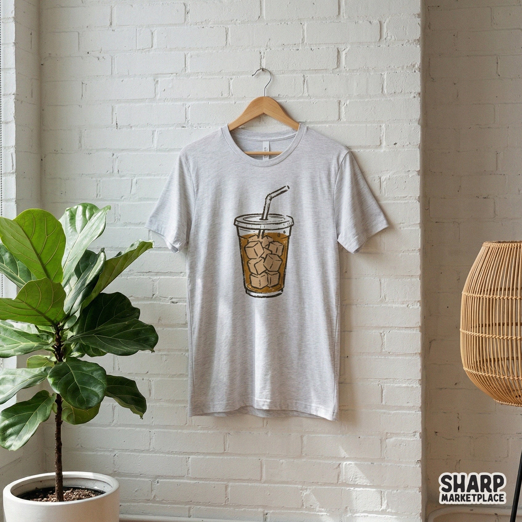 A trendy iced coffee cup graphic featuring a retro, grainy texture displayed on a heather gray t-shirt for apparel or sublimation projects.