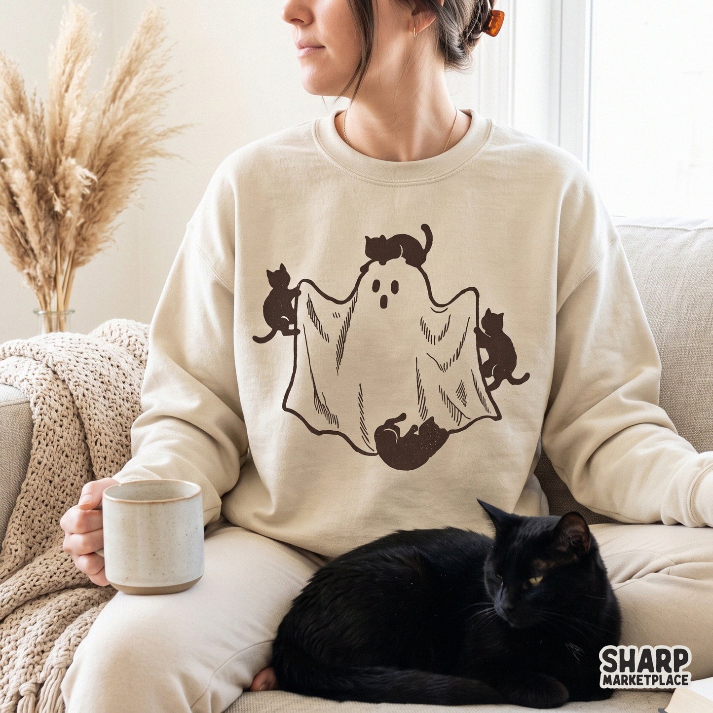 Three black cats playing with a white sheet ghost in a cute retro style for spooky season Halloween t-shirts and fall decor