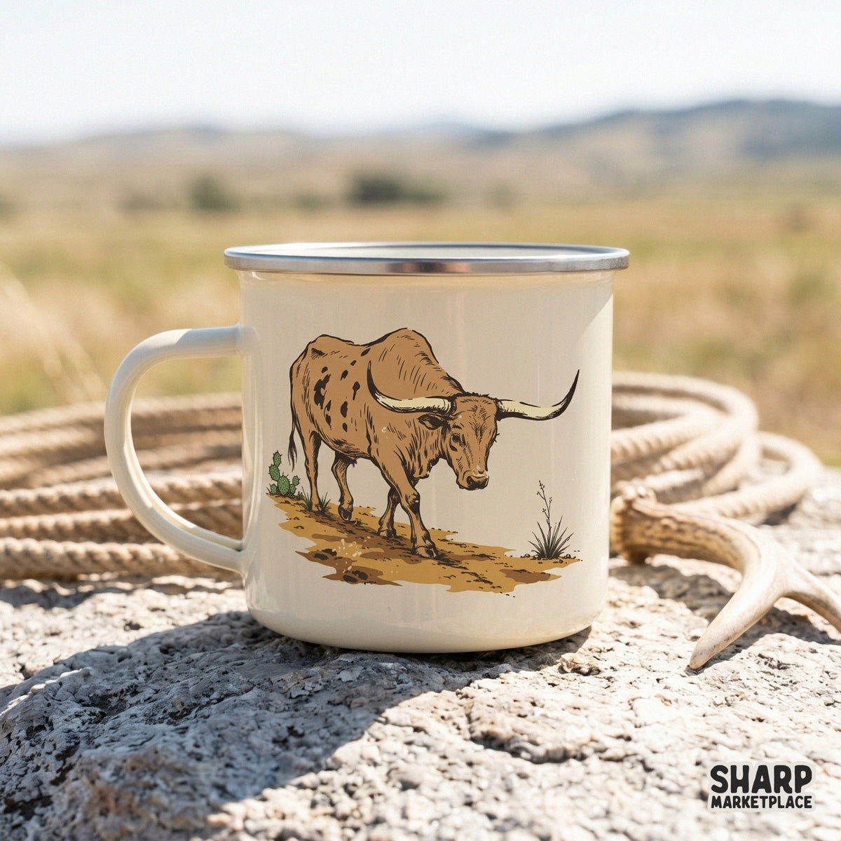 Rustic western longhorn bull illustration printed on a white enamel camping mug, featuring a detailed steer, desert brush, and a cactus.