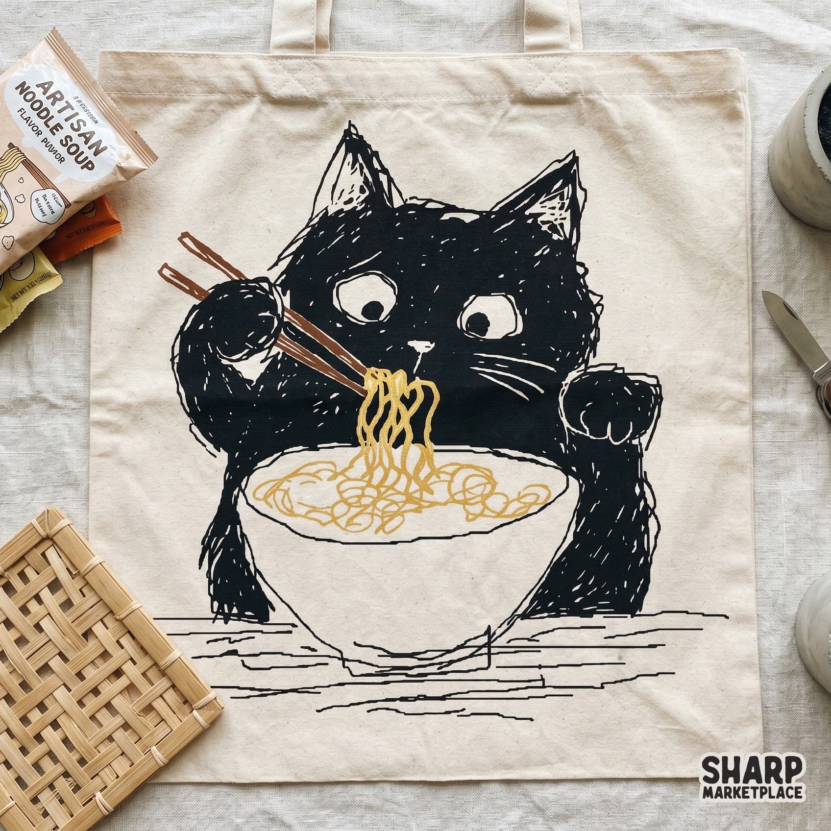 Funny black kitty enjoying a bowl of ramen, a high-resolution digital graphic for creating unique cat-themed clothing and foodie wall art prints.