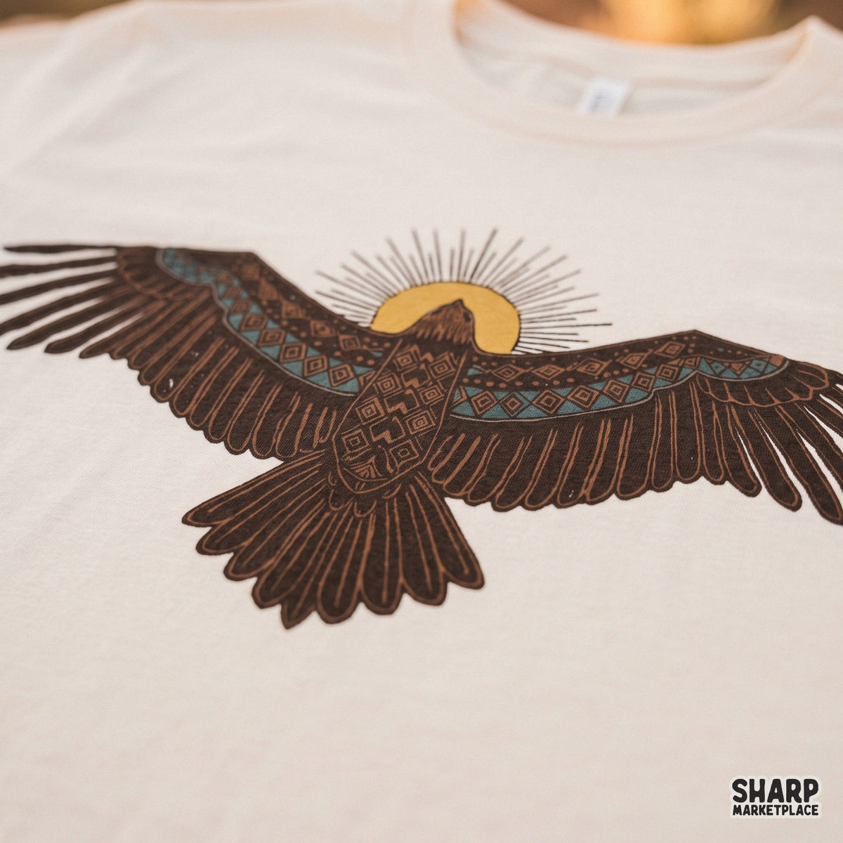 Southwestern thunderbird with geometric patterns and a yellow sun in retro western png style for t-shirts