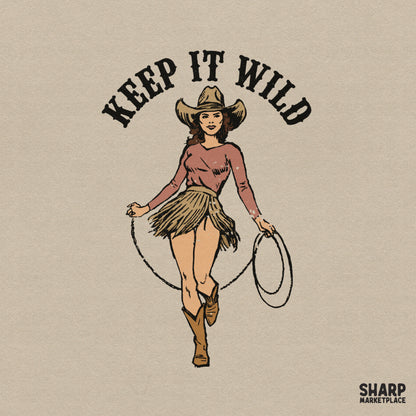 Retro western graphic featuring a cowgirl in a hat and fringed skirt twirling a lasso with the arched text Keep It Wild in a vintage style.