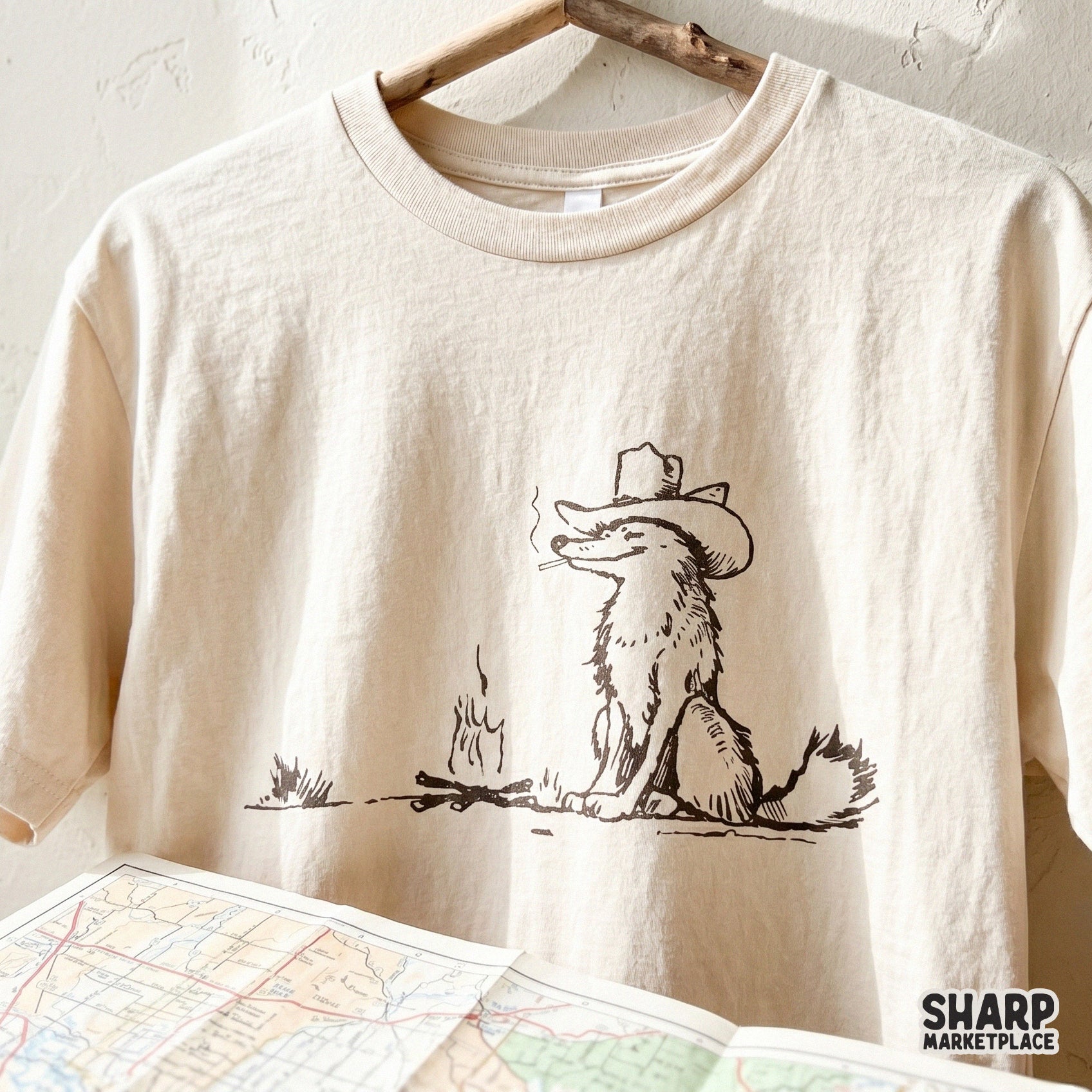 Detailed western-style digital graphic of a woodland fox relaxing at a campfire, suitable for creating unique tumblers, wall art, and camping apparel.