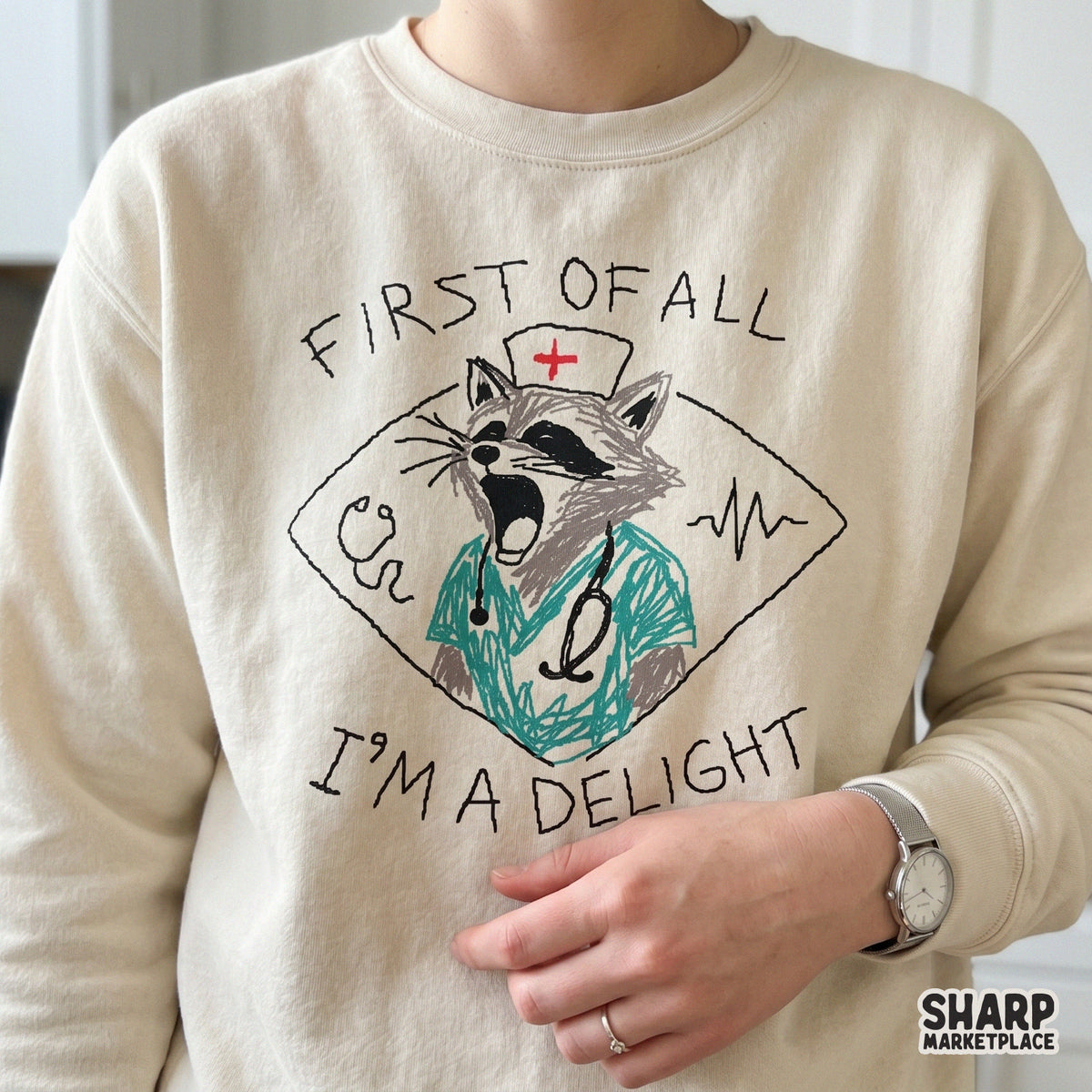 Sarcastic healthcare digital download featuring a raccoon in a nurse cap and scrubs with the text First Of All I'm A Delight for DIY shirts and tumblers.