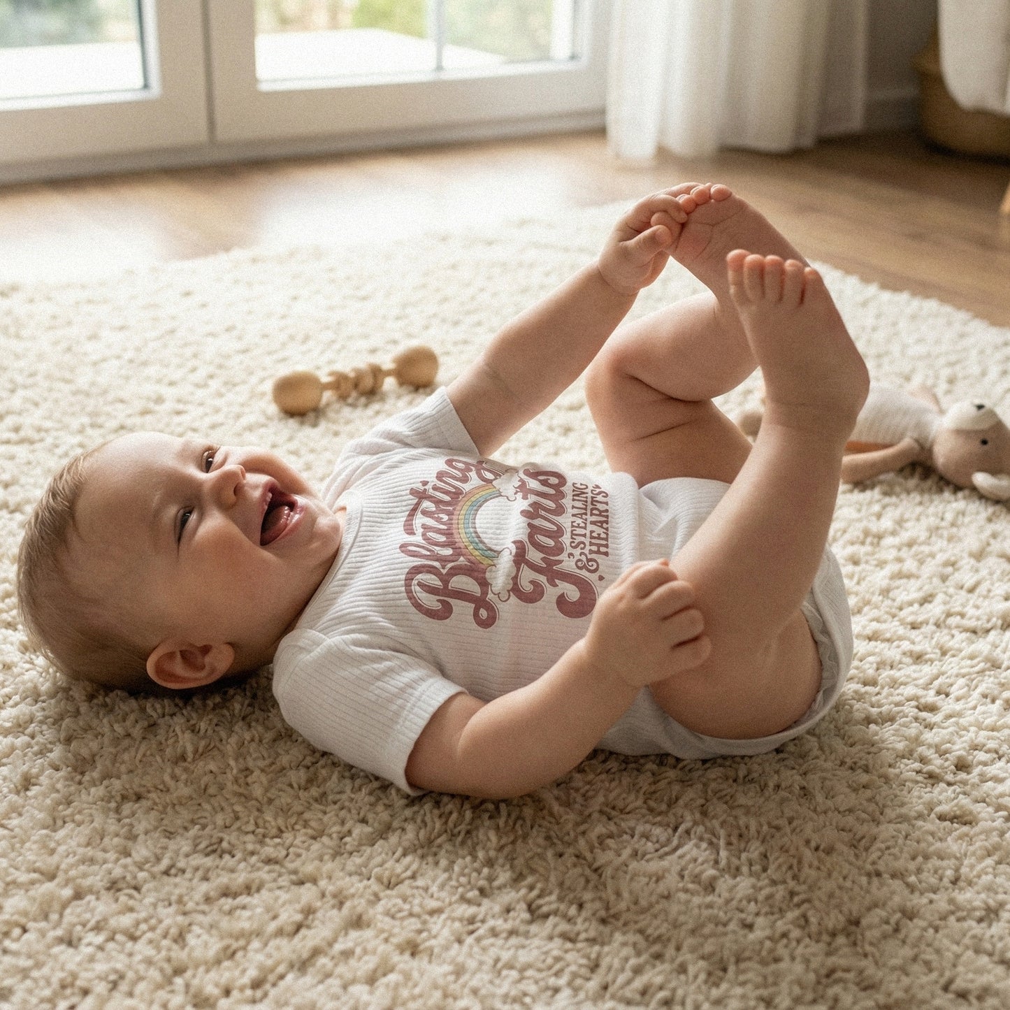 Funny kids apparel design featuring a retro rainbow, clouds, and text saying Blasting Farts and Stealing Hearts, perfect for sublimation and DIY shirts.