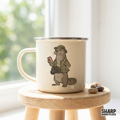 A cream-colored enamel camping mug featuring a whimsical illustration of an adventurous otter photographer wearing a vest and hat.