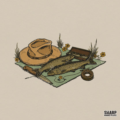 Vintage fly fishing digital design featuring two trout, a wide-brimmed hat, a fly reel, and a knife on a green mat with yellow wildflowers for apparel.