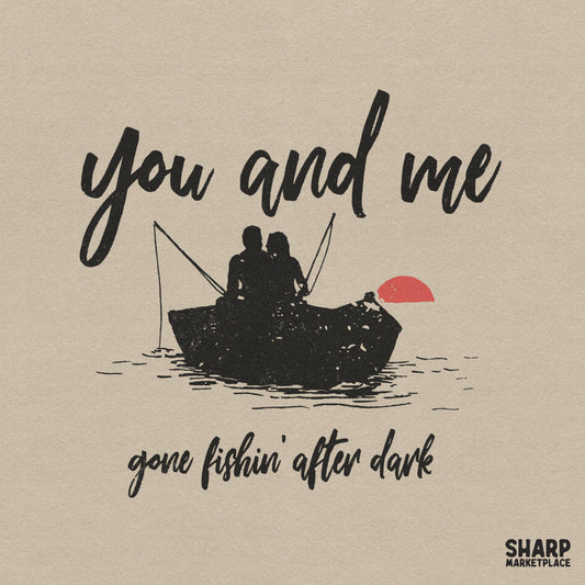 Retro fishing design featuring a silhouette of a couple in a boat under a red sun with the text You and me gone fishin' after dark in script font.