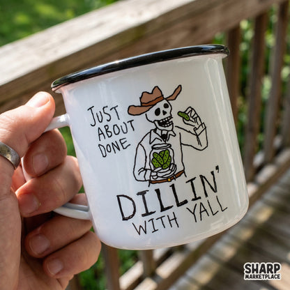 Enamel mug featuring a cowboy skeleton holding a pickle jar and a pickle with the sarcastic text Just About Done Dillin With Yall.