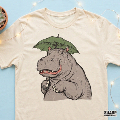 Cute smiling hippopotamus holding a green umbrella rainy day sublimation PNG design for t-shirts