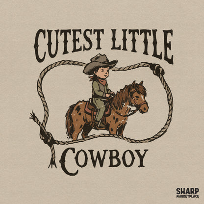 Retro western digital design featuring a young cowboy on a spotted pony inside a rustic rope loop with the text Cutest Little Cowboy.