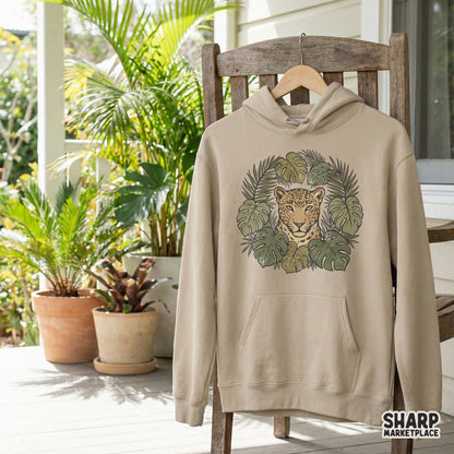 Detailed leopard portrait framed by lush tropical foliage in olive and tan colors, perfect for custom t-shirt designs and nature-themed art.