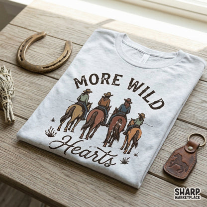 Western style graphic print for DIY projects featuring four cowgirls riding horses through a desert scene with the vintage text More Wild Hearts.