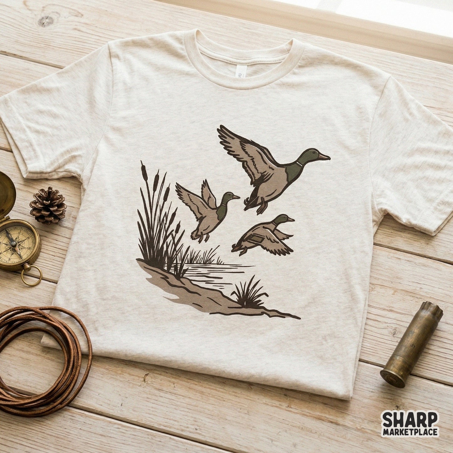 High-resolution transparent PNG file featuring a trio of mallards in flight over pond grass, designed for custom hunting apparel and DIY projects.
