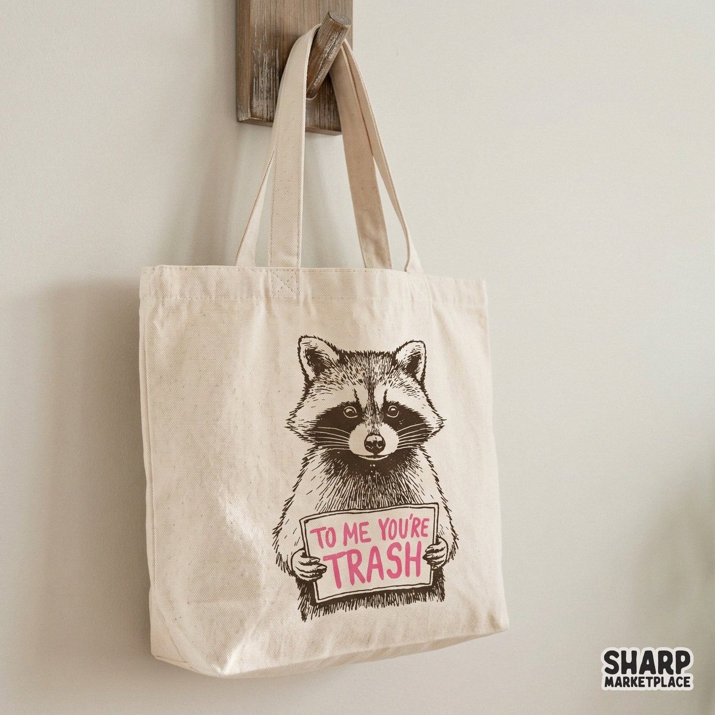 Snarky animal design featuring a realistic raccoon with a sign reading To Me You Are Trash, ideal for high-quality sublimation and custom clothing prints.