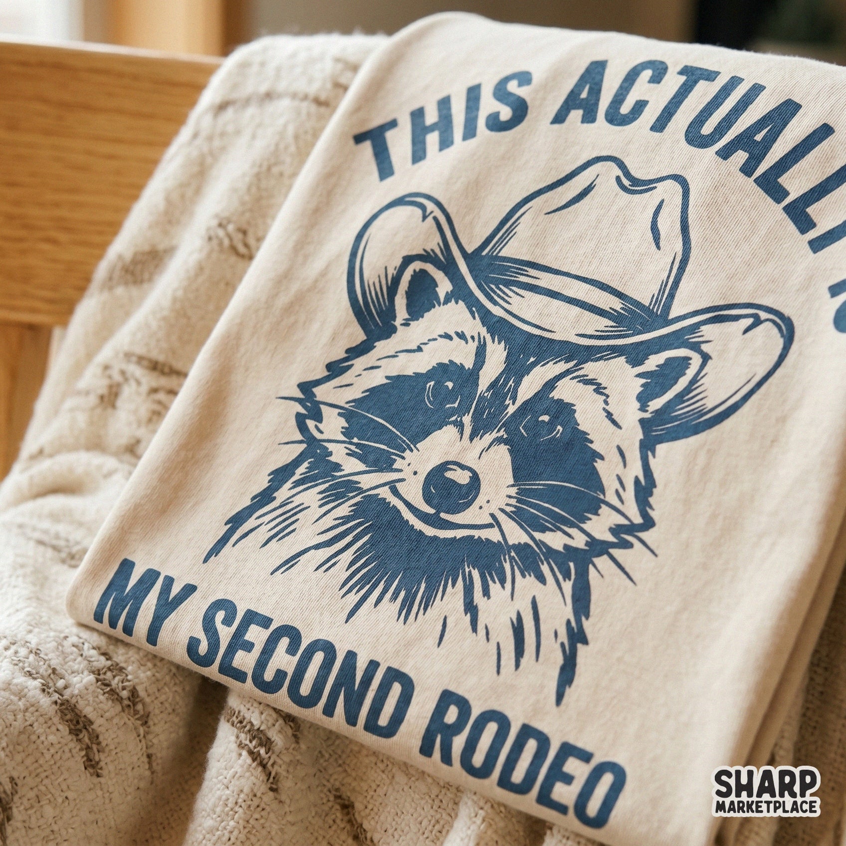 Monochromatic western raccoon graphic with distressed texture and humorous text for DIY apparel, stickers, or sublimation projects on various surfaces.
