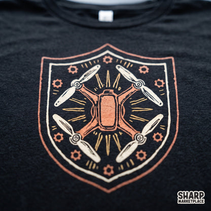 Vintage drone shield emblem featuring a quadcopter crest and mechanical gears PNG for shirt printing
