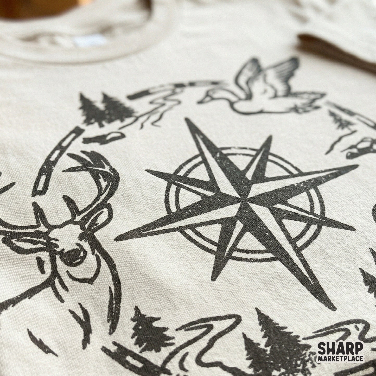 Detailed western compass PNG design with a deer, flying duck, and jumping fish, perfect for sublimation, apparel, or rustic cabin wall art.