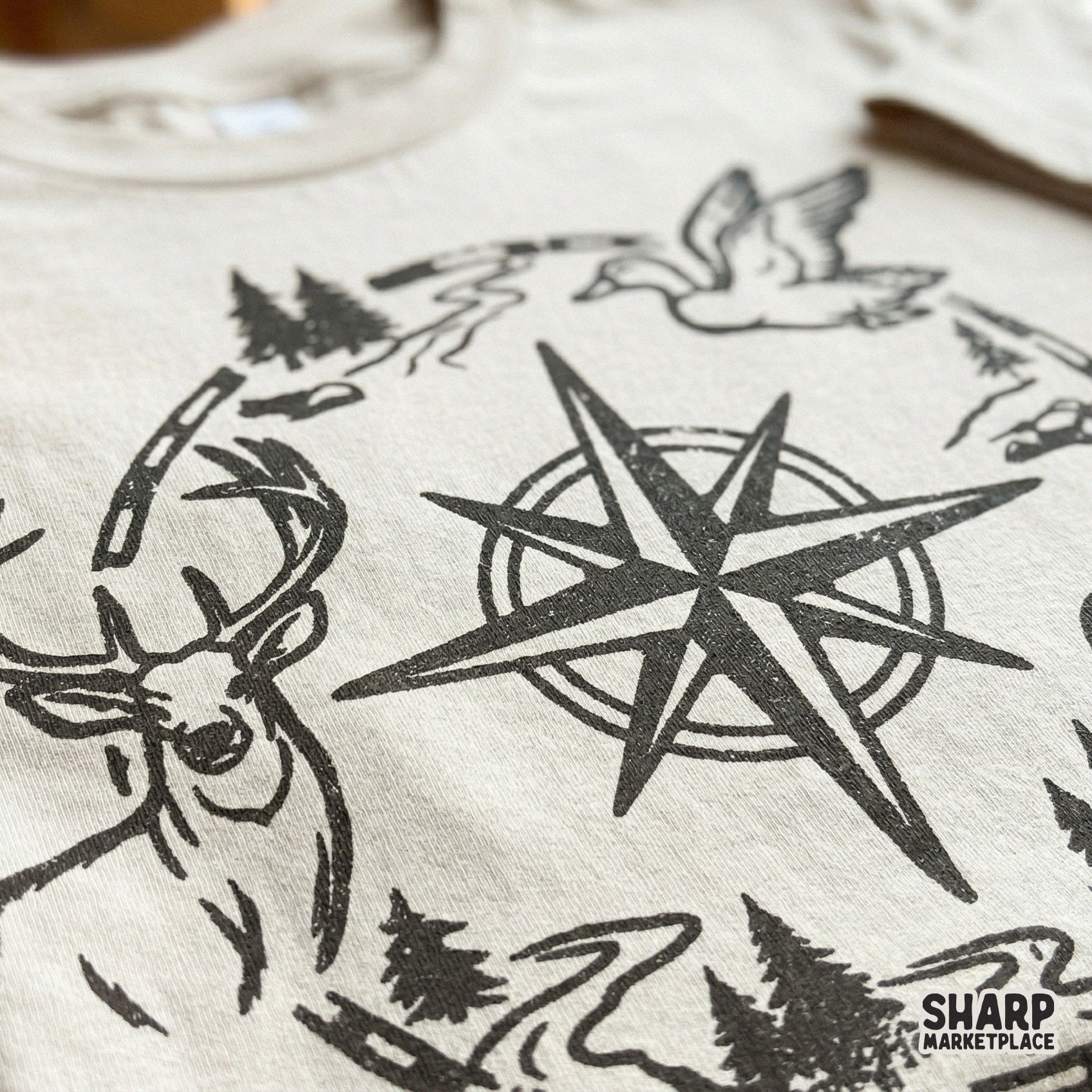Detailed western compass PNG design with a deer, flying duck, and jumping fish, perfect for sublimation, apparel, or rustic cabin wall art.
