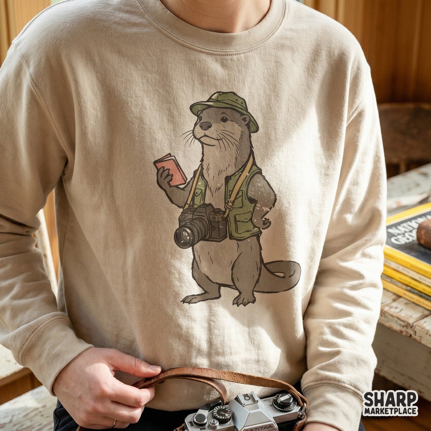 Digital design of a charming river otter explorer dressed in safari gear with a camera, perfect for nature-themed apparel or sticker projects.