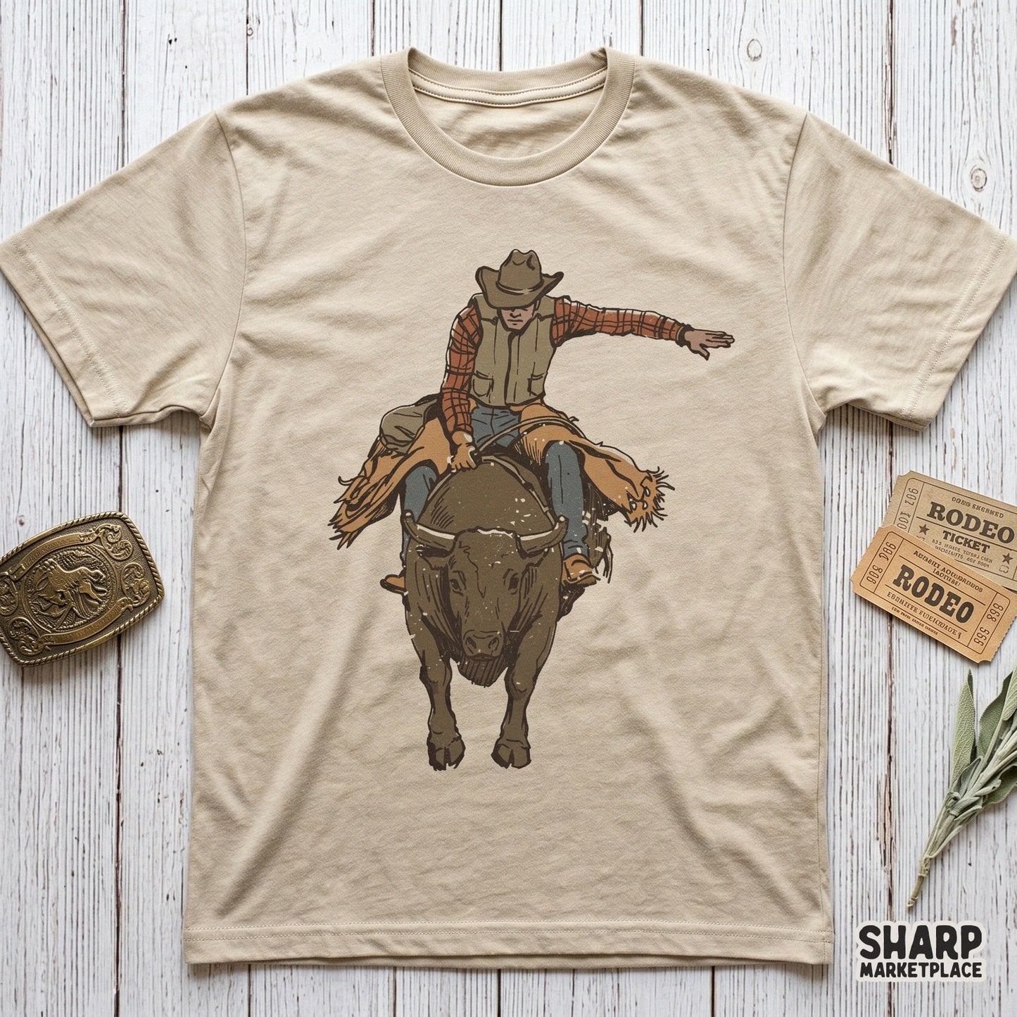 Detailed retro rodeo cowboy graphic on a tan t-shirt mockup, showing a bull riding scene suitable for western-themed clothing and DIY projects.