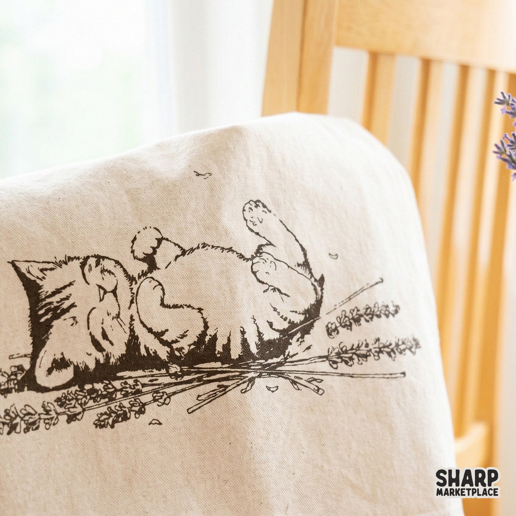 Cute sleeping kitten surrounded by lavender flowers in a heart aesthetic for vintage cottagecore apparel and stickers