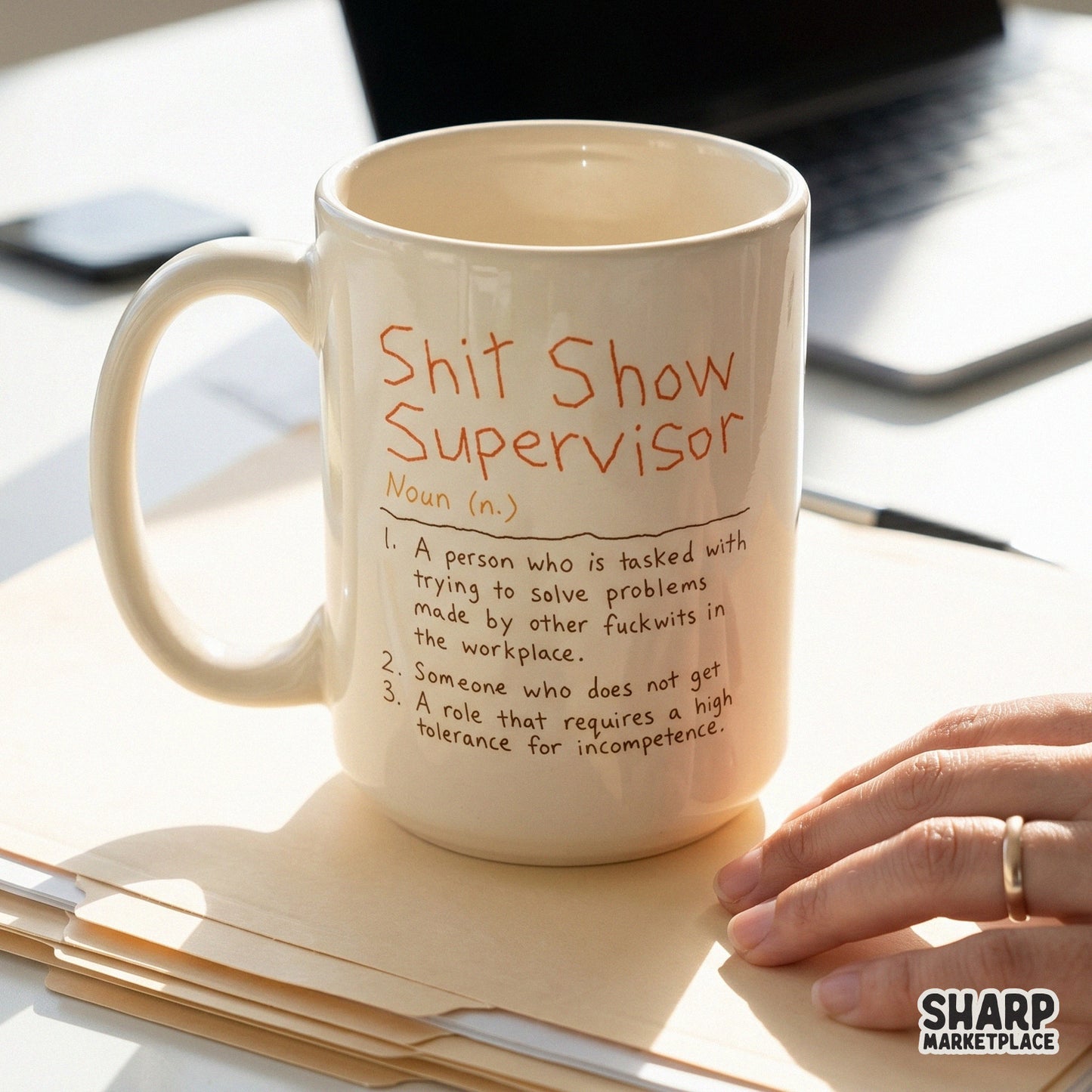 Digital design of a funny workplace definition featuring orange-red handwritten text on a neutral background for sublimation and custom mugs.