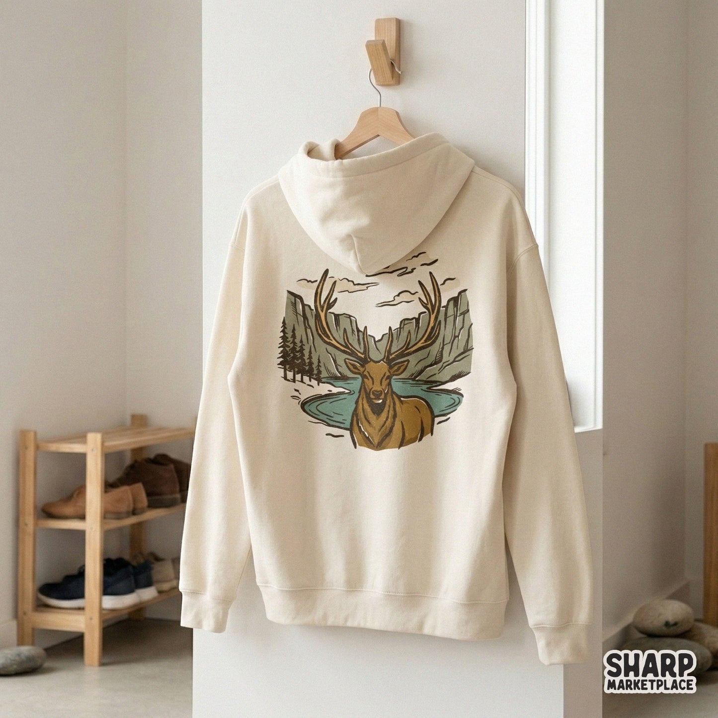 Hand-drawn bull elk wilderness scene featuring a blue lake, rocky mountains, and pine trees in earthy tones for retro shirts, stickers, and home decor.