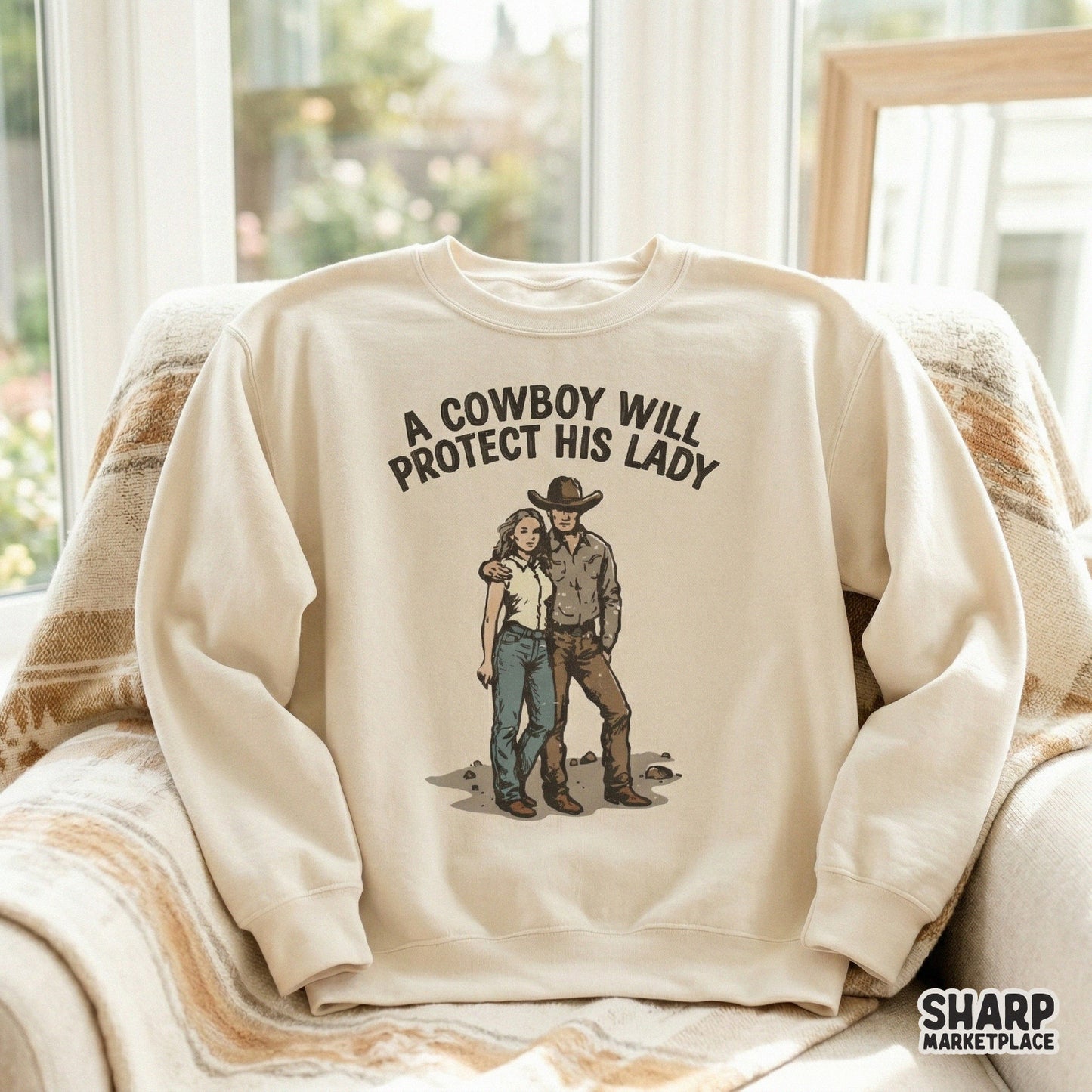 Cream-colored sweatshirt mockup displaying a vintage-inspired western illustration of a couple with the quote A Cowboy Will Protect His Lady.