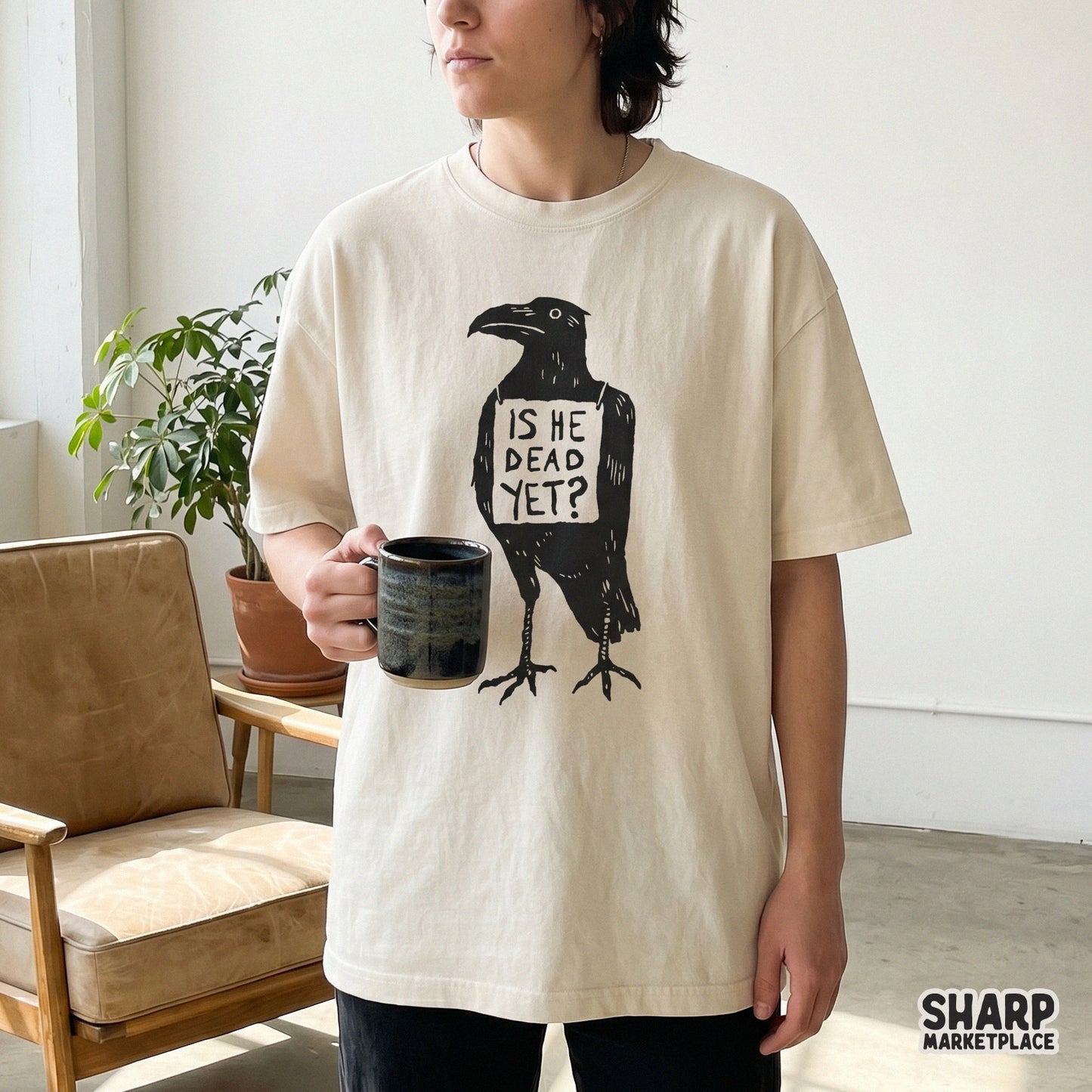 A sarcastic crow graphic with a sign saying Is He Dead Yet printed on a cream t-shirt, perfect for spooky apparel and DIY sublimation projects.