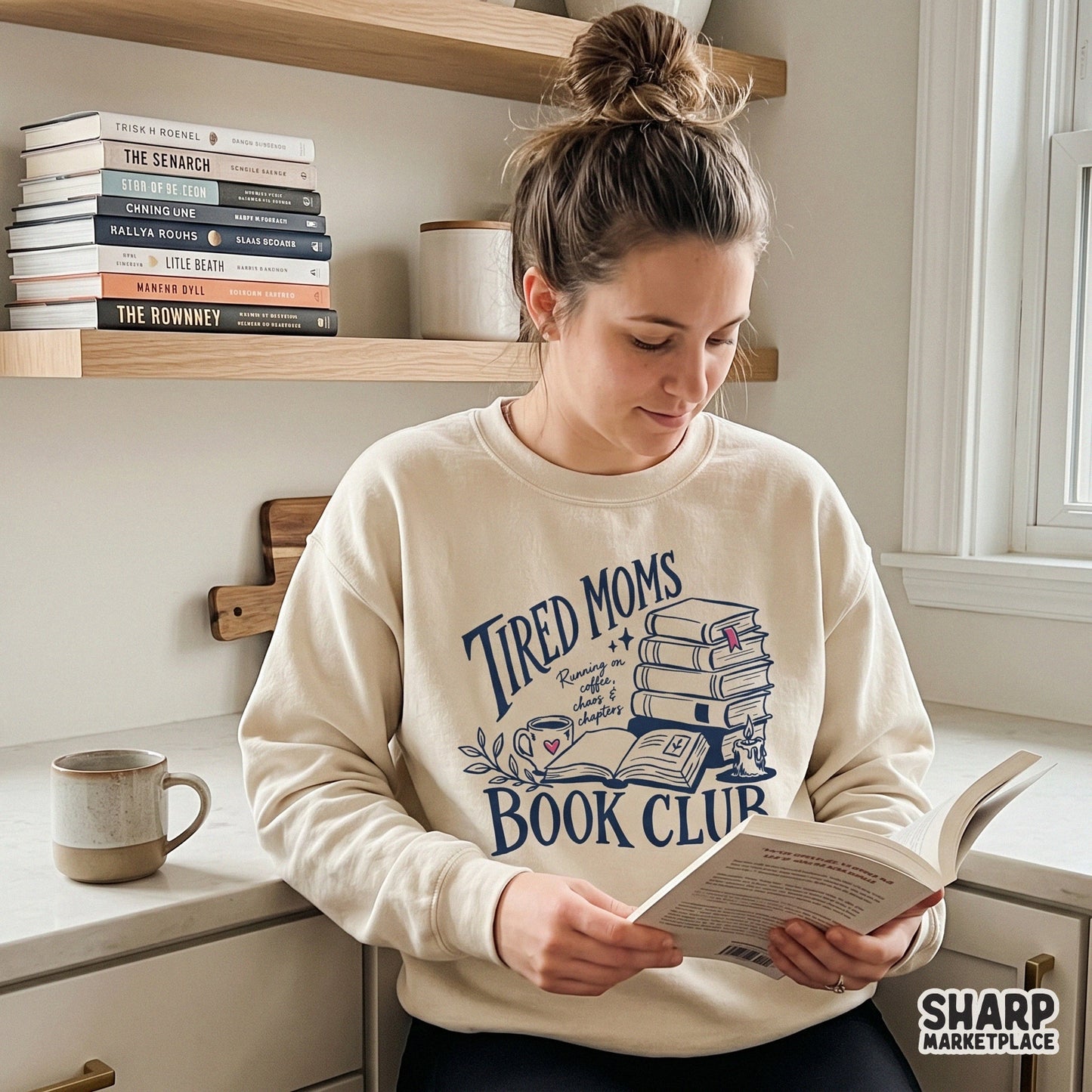 Digital apparel design showing a stack of books, a coffee mug, and a candle with the quote Tired Moms Book Club, perfect for sublimation or DTF shirt printing.