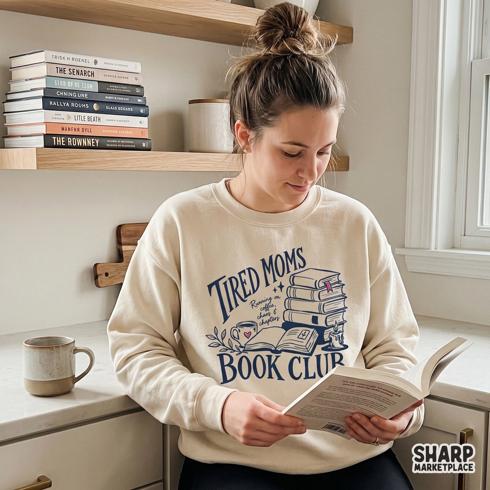 Digital apparel design showing a stack of books, a coffee mug, and a candle with the quote Tired Moms Book Club, perfect for sublimation or DTF shirt printing.