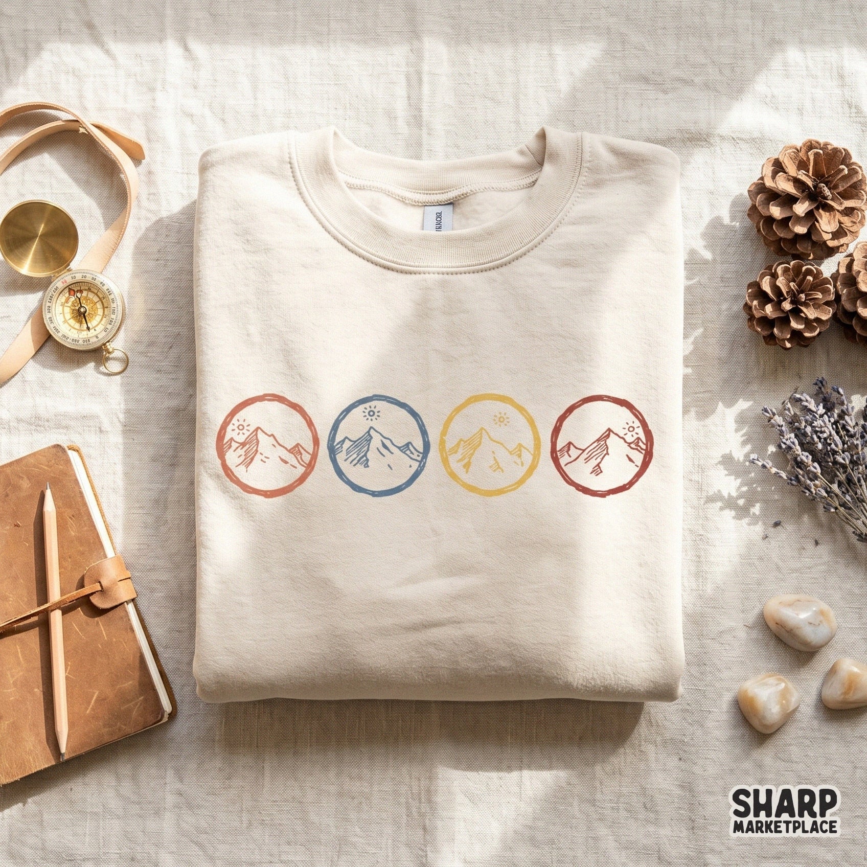Digital download of four minimalist alpine landscape badges with a sun rising over rugged peaks, rendered in a textured, linocut style for DIY crafts.