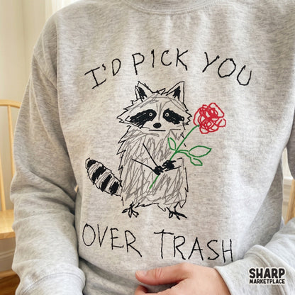 Quirky hand-lettered design with a sketchy raccoon holding a flower, ideal for DIY gifts, funny valentines, or custom apparel and sublimation projects.