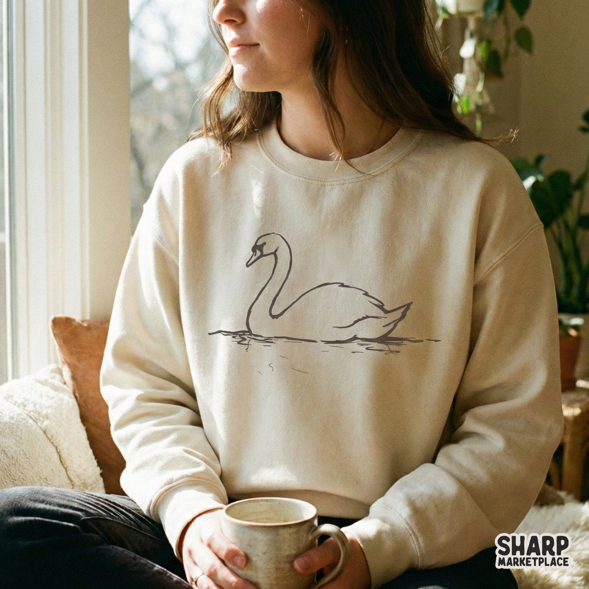 Elegant minimalist swan line art design centered on a beige sweatshirt, perfect for apparel printing, sublimation, or custom DIY projects.