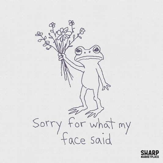 Hand-drawn line art of a grumpy frog holding a bouquet of flowers with the text Sorry for what my face said, perfect for funny apparel designs.