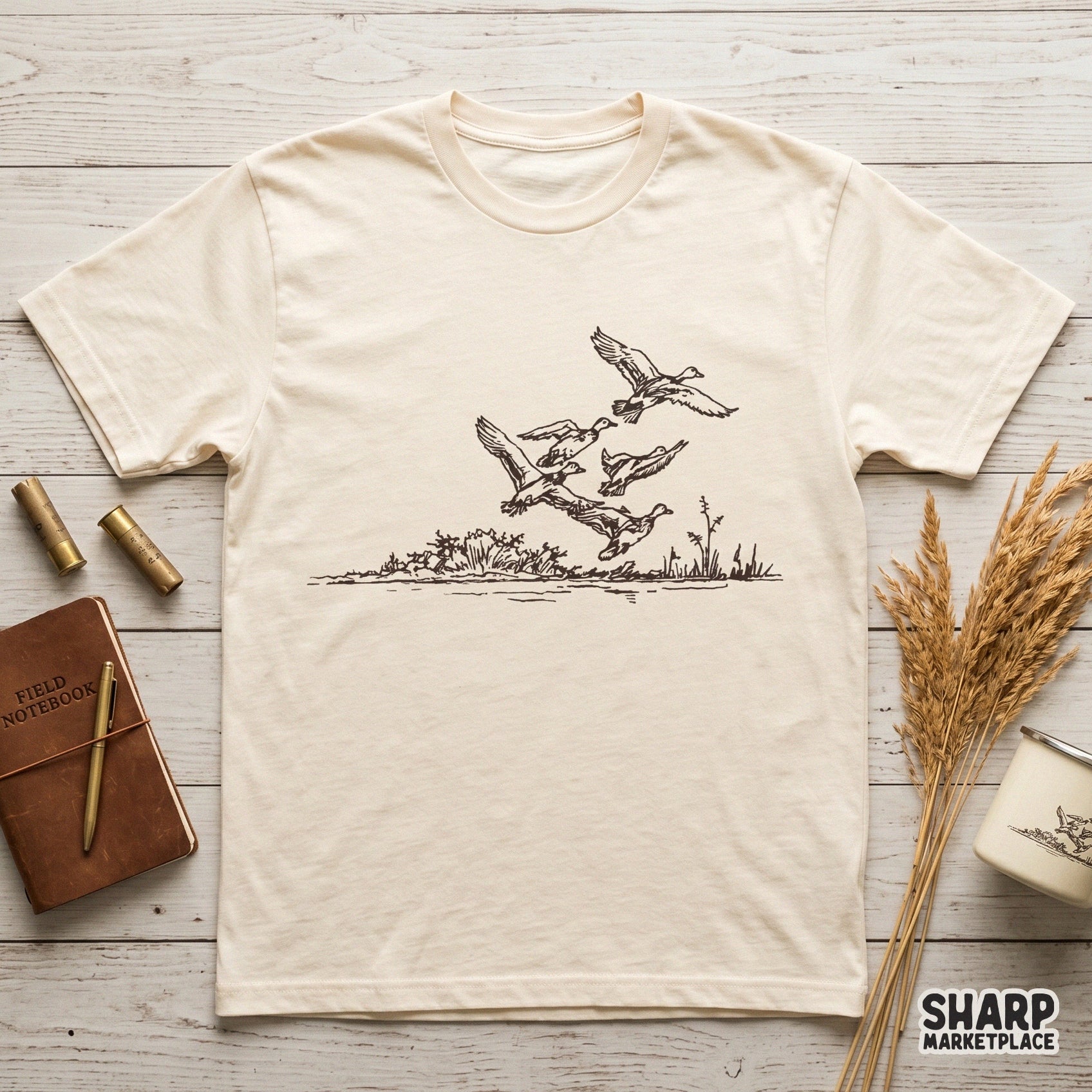 Detailed digital illustration of waterfowl in flight above a rustic reed line, designed for sublimation, stickers, or custom outdoor-themed apparel projects.