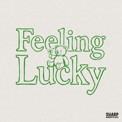 Retro green line art design featuring a cute teddy bear holding a four-leaf clover with the text Feeling Lucky for St. Patrick's Day apparel.