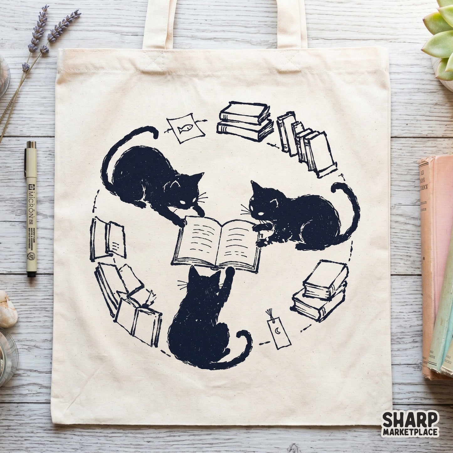 Hand-drawn illustration of three black kittens gathered around an open book, featuring a crescent moon charm and books, perfect for sublimation prints.