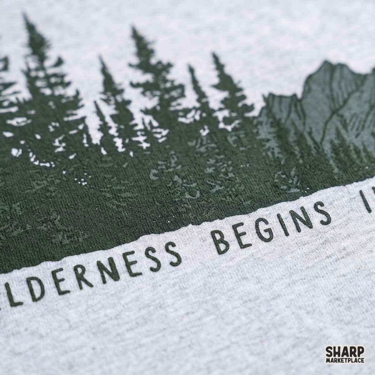 Wilderness begins in the mind quote with vintage pine trees and western retro mountain art for camping shirt designs
