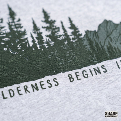 Wilderness begins in the mind quote with vintage pine trees and western retro mountain art for camping shirt designs