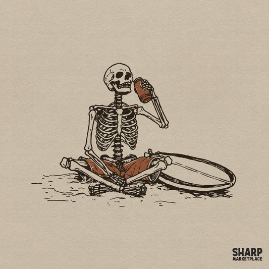 Vintage style illustration of a skeleton sitting on the sand with a surfboard, drinking from a coconut, perfect for summer or Halloween apparel.