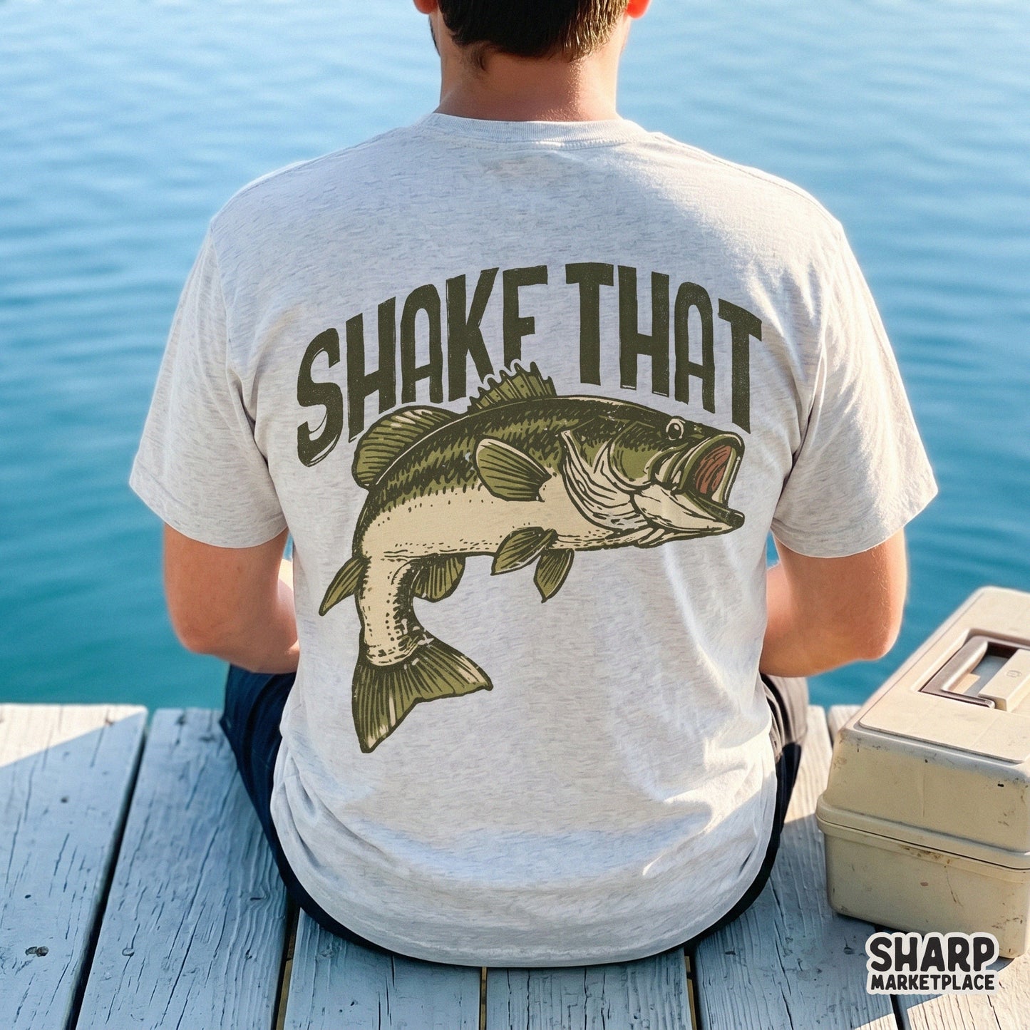 Back view of a light gray t-shirt displaying a rustic fishing graphic with a leaping bass and bold text for lake-themed sublimation projects.