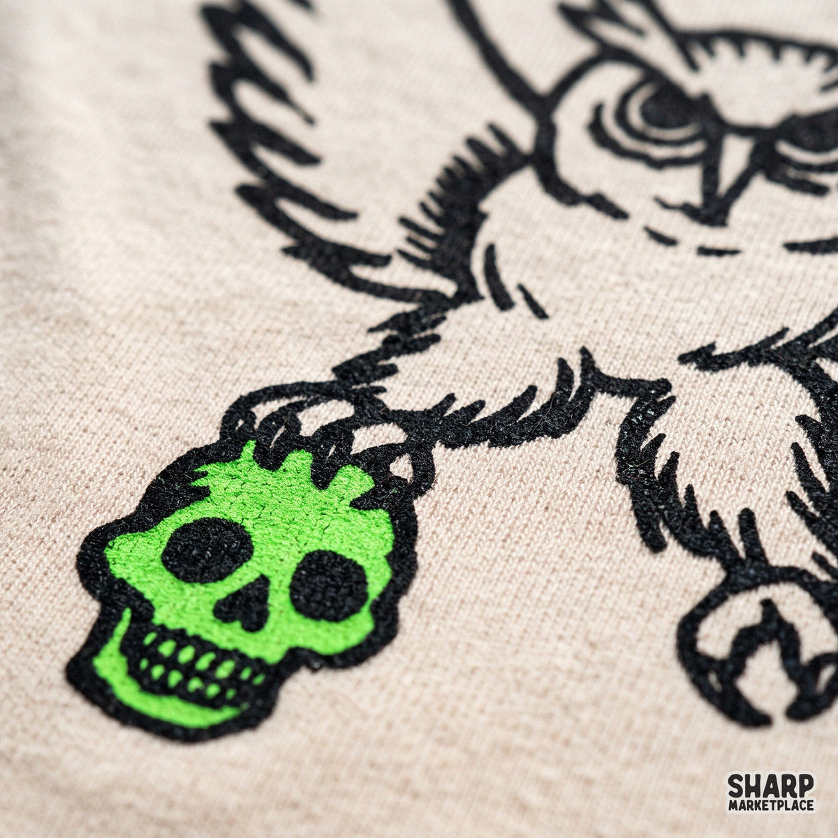 Fierce owl carrying a green skull in its talons halloween png graphic for gothic streetwear and spooky t-shirt design