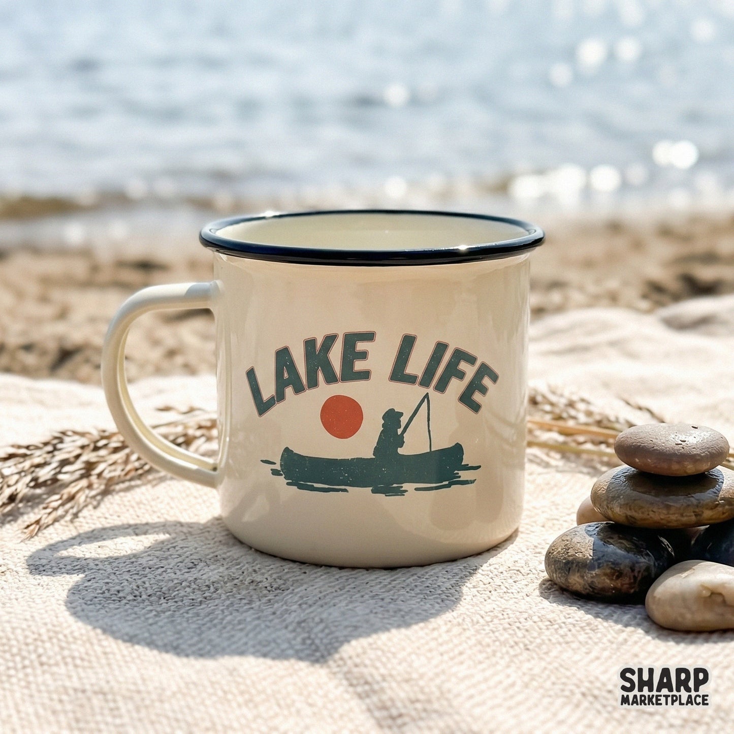 Hand-drawn silhouette of a person in a canoe with a fishing pole, set against a sunset circle with arched Lake Life text for outdoor apparel.