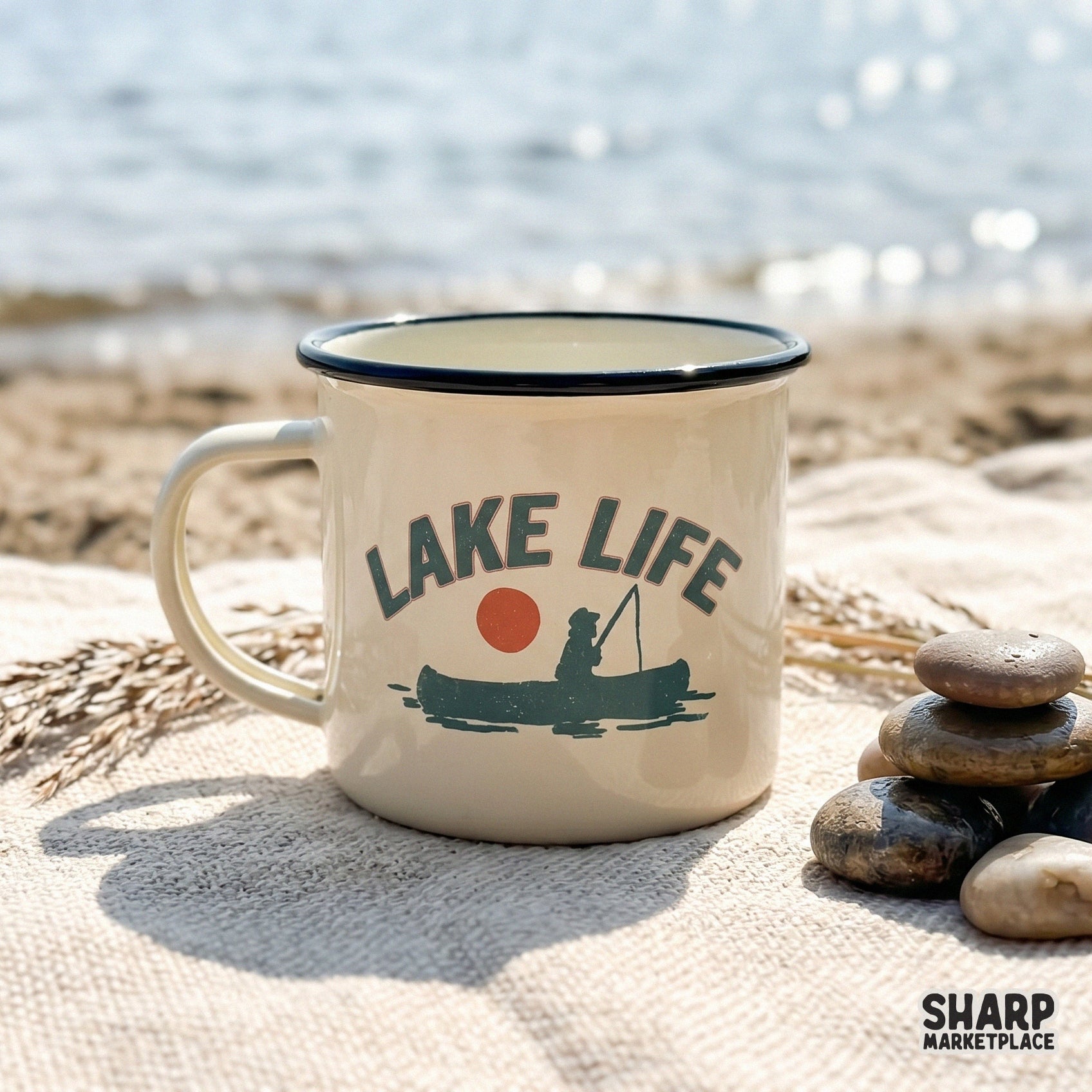 Hand-drawn silhouette of a person in a canoe with a fishing pole, set against a sunset circle with arched Lake Life text for outdoor apparel.