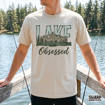 Trendy Lake Obsessed graphic on a t-shirt mockup showcasing a scenic mountain and water illustration for summer vacation clothing and DIY projects.