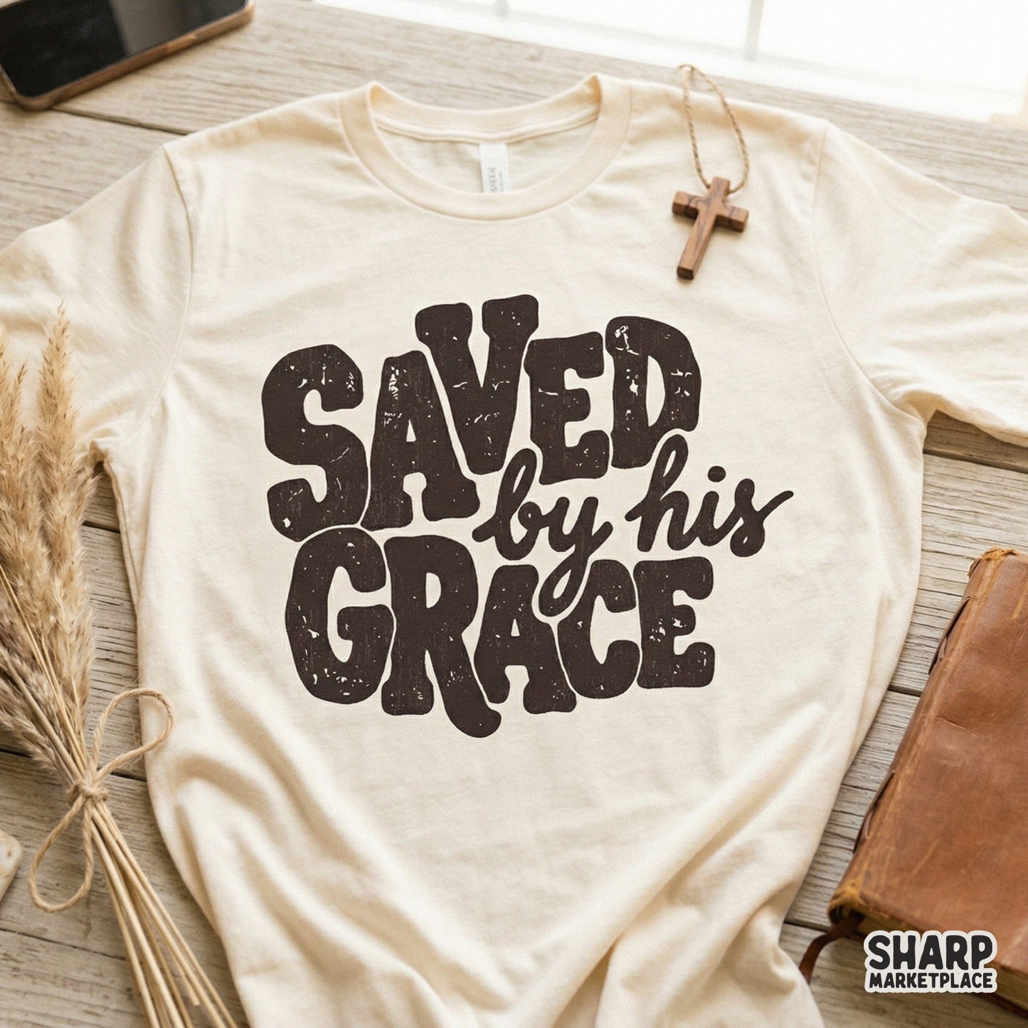 Faith-based digital design with a distressed texture, featuring the quote Saved By His Grace in a mix of block and script fonts for DIY crafts.