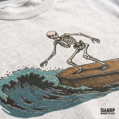 Vintage skeleton surfing on a coffin graphic for a summer beach tee shirt design